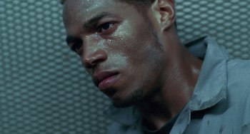 Movie still from “Requiem for a Dream” (2000), directed by Darren Aronofsky – A person with sweat on his face; Close Up shot, Low angle