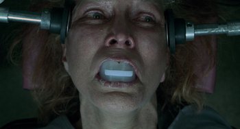 Movie still from “Requiem for a Dream” (2000), directed by Darren Aronofsky – A person wearing headphones with their mouth wide open; Close Up shot, Overhead angle