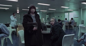 Movie still from “Requiem for a Dream” (2000), directed by Darren Aronofsky – A man and a woman are standing next to each other in a room; Medium shot, Low angle