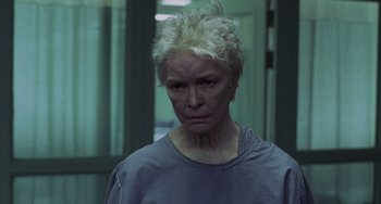 Movie still from “Requiem for a Dream” (2000), directed by Darren Aronofsky – An older woman with white hair is looking at the camera; Close Up shot, Low angle