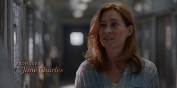 Movie still from “Rescued by Ruby” (2022), directed by Katt Shea – A person wearing a plaid shirt; Close Up shot, High angle