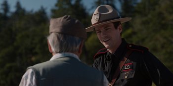 Movie still from “Rescued by Ruby” (2022), directed by Katt Shea – A man in a uniform talking to a man in an older man; Close Up shot, Over the shoulder angle