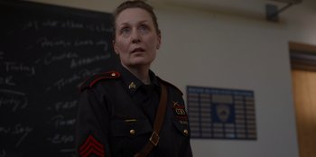 Movie still from “Rescued by Ruby” (2022), directed by Katt Shea – A woman in a military uniform looking to her left; Close Up shot, Over the shoulder angle