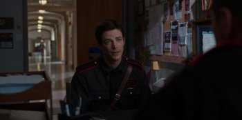 Movie still from “Rescued by Ruby” (2022), directed by Katt Shea – A man in a uniform sitting at a table; Medium shot, Over the shoulder angle