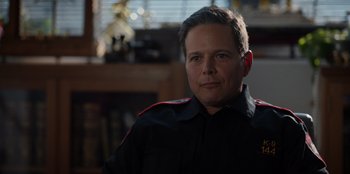 Movie still from “Rescued by Ruby” (2022), directed by Katt Shea – A person wearing a uniform; Close Up shot, Over the shoulder angle