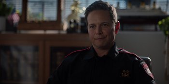 Movie still from “Rescued by Ruby” (2022), directed by Katt Shea – A person wearing a uniform; Close Up shot, Over the shoulder angle