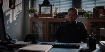 Movie still from “Rescued by Ruby” (2022), directed by Katt Shea – A man sitting in front of a computer keyboard; Medium shot, Over the shoulder angle