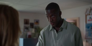 Movie still from “Rescued by Ruby” (2022), directed by Katt Shea – A person wearing a green shirt; Close Up shot, Low angle