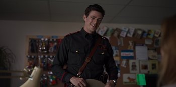 Movie still from “Rescued by Ruby” (2022), directed by Katt Shea – A man in a uniform is holding a hat; Medium shot, Over the shoulder angle