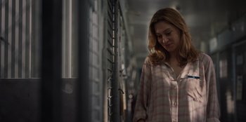 Movie still from “Rescued by Ruby” (2022), directed by Katt Shea – A woman standing in front of a train window; Close Up shot, Over the shoulder angle