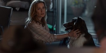 Movie still from “Rescued by Ruby” (2022), directed by Katt Shea – A woman is petting a dog on her shoulder; Close Up shot, Over the shoulder angle