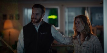 Movie still from “Rescued by Ruby” (2022), directed by Katt Shea – A man and a woman standing next to each other in a room; Medium shot, Over the shoulder angle