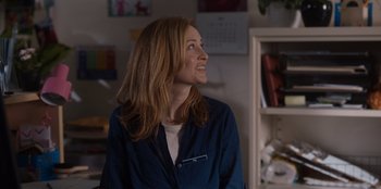 Movie still from “Rescued by Ruby” (2022), directed by Katt Shea – A woman with long hair is looking to the side; Medium shot, Over the shoulder angle