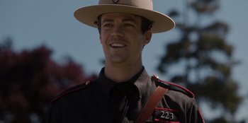 Movie still from “Rescued by Ruby” (2022), directed by Katt Shea – A person wearing a uniform and a hat; Close Up shot, Over the shoulder angle