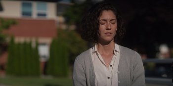 Movie still from “Rescued by Ruby” (2022), directed by Katt Shea – A woman with her eyes closed is standing outside; Close Up shot, High angle