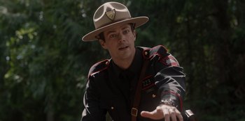 Movie still from “Rescued by Ruby” (2022), directed by Katt Shea – A man wearing a uniform and a hat; Close Up shot, Over the shoulder angle