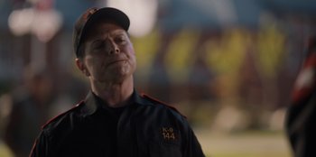 Movie still from “Rescued by Ruby” (2022), directed by Katt Shea – A person wearing a uniform; Close Up shot, Over the shoulder angle