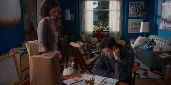 Movie still from “Rescued by Ruby” (2022), directed by Katt Shea – A man sitting at a table in front of a dog; Medium shot, Over the shoulder angle