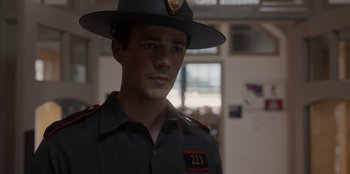Movie still from “Rescued by Ruby” (2022), directed by Katt Shea – A man in a uniform is wearing a hat; Close Up shot, Over the shoulder angle