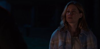 Movie still from “Rescued by Ruby” (2022), directed by Katt Shea – A woman standing in the dark with her mouth open; Close Up shot, Over the shoulder angle