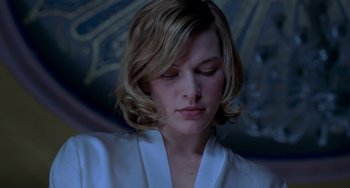 Movie still from “Resident Evil” (2002), directed by Paul W.S. Anderson – A person wearing a white shirt; Close Up shot, Low angle