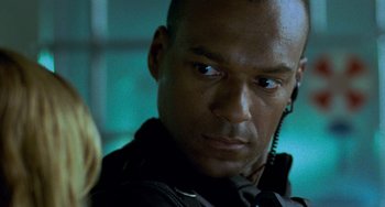 Movie still from “Resident Evil” (2002), directed by Paul W.S. Anderson – A person wearing a black jacket; Close Up shot, Over the shoulder angle