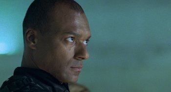 Movie still from “Resident Evil” (2002), directed by Paul W.S. Anderson – A man's face with tears in his eyes; Close Up shot, Low angle