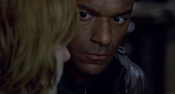 Movie still from “Resident Evil” (2002), directed by Paul W.S. Anderson – A person looking at the camera; Close Up shot, Over the shoulder angle