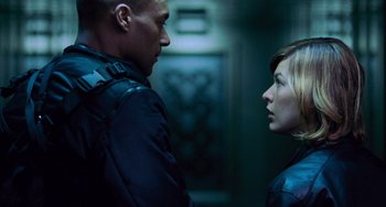 Movie still from “Resident Evil” (2002), directed by Paul W.S. Anderson – A man and a woman standing next to each other; Close Up shot, Low angle