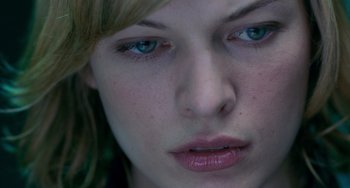Movie still from “Resident Evil” (2002), directed by Paul W.S. Anderson – A woman's face with blue eyes; Extreme Close Up shot, Overhead angle