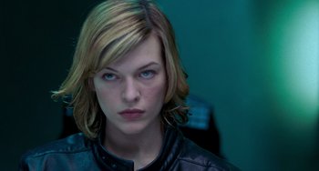 Movie still from “Resident Evil” (2002), directed by Paul W.S. Anderson – A person wearing a leather jacket; Close Up shot, Low angle