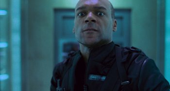 Movie still from “Resident Evil” (2002), directed by Paul W.S. Anderson – A man in black jacket looking up at the camera; Close Up shot, Low angle
