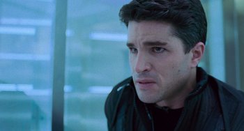 Movie still from “Resident Evil” (2002), directed by Paul W.S. Anderson – A person wearing a black jacket; Close Up shot, Over the shoulder angle