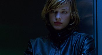Movie still from “Resident Evil” (2002), directed by Paul W.S. Anderson – A person wearing a leather jacket; Close Up shot, Low angle