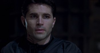 Movie still from “Resident Evil” (2002), directed by Paul W.S. Anderson – A person wearing headphones; Close Up shot, Over the shoulder angle