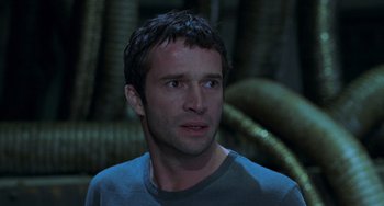 Movie still from “Resident Evil” (2002), directed by Paul W.S. Anderson – A person wearing a gray t - shirt; Close Up shot, Low angle