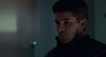 Movie still from “Resident Evil” (2002), directed by Paul W.S. Anderson – A person wearing a black jacket; Close Up shot, Over the shoulder angle