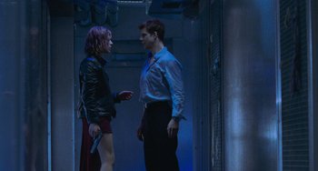 Movie still from “Resident Evil” (2002), directed by Paul W.S. Anderson – A man and a woman standing next to each other; Wide shot, Low angle