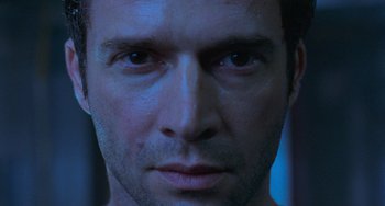 Movie still from “Resident Evil” (2002), directed by Paul W.S. Anderson – A man's face in the dark; Close Up shot, Low angle