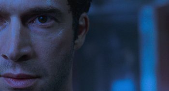 Movie still from “Resident Evil” (2002), directed by Paul W.S. Anderson – A man's face in the dark; Extreme Close Up shot, Over the shoulder angle