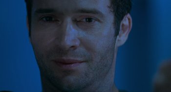 Movie still from “Resident Evil” (2002), directed by Paul W.S. Anderson – A man's face in the dark; Extreme Close Up shot, Over the shoulder angle