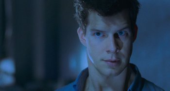 Movie still from “Resident Evil” (2002), directed by Paul W.S. Anderson – A person wearing a blue shirt; Close Up shot, Over the shoulder angle
