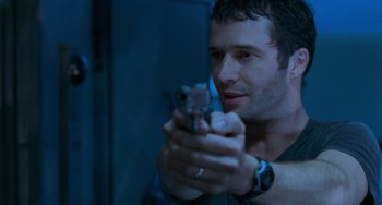 Movie still from “Resident Evil” (2002), directed by Paul W.S. Anderson – A person holding a cell phone; Close Up shot, Over the shoulder angle