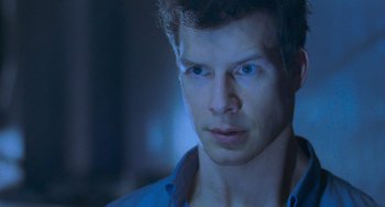 Movie still from “Resident Evil” (2002), directed by Paul W.S. Anderson – A person wearing a blue shirt; Close Up shot, Over the shoulder angle