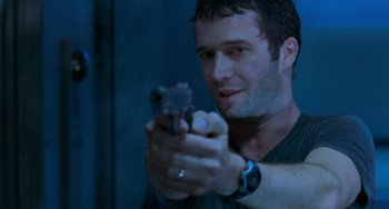 Movie still from “Resident Evil” (2002), directed by Paul W.S. Anderson – A man holding a gun in his hand; Close Up shot, Low angle
