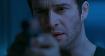 Movie still from “Resident Evil” (2002), directed by Paul W.S. Anderson – A person holding a cell phone; Extreme Close Up shot, Low angle