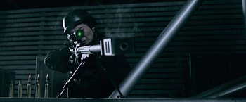 Movie still from “Resident Evil: Afterlife” (2010), directed by Paul W.S. Anderson – A man with a rifle aiming at something in the dark; Medium shot, High angle