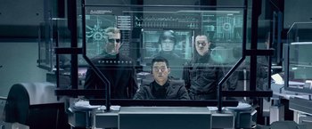 Movie still from “Resident Evil: Afterlife” (2010), directed by Paul W.S. Anderson – A group of men sitting next to each other in front of a computer screen; Medium shot, Over the shoulder angle