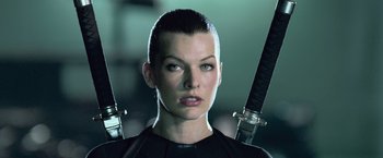 Movie still from “Resident Evil: Afterlife” (2010), directed by Paul W.S. Anderson – A person holding a pair of swords; Close Up shot, Low angle