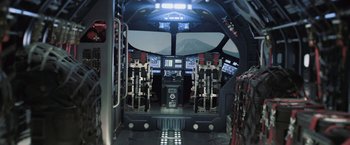 Movie still from “Resident Evil: Afterlife” (2010), directed by Paul W.S. Anderson – The inside of a plane with a view of a mountain in the background; Wide shot, High angle